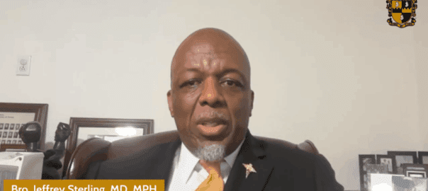 Man speaking in a formal setting.